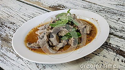 Esan`s food, Scalding Liver pork with spicy garnish in dish on Stock Photo