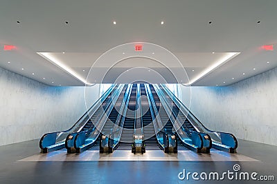 Escalator with blue light coming from upstairs Stock Photo