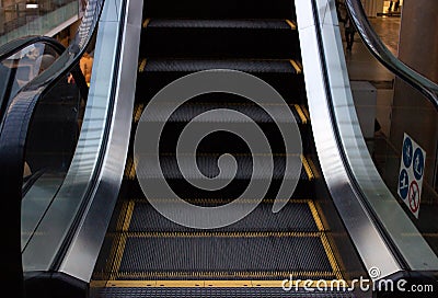 Escalator in Community Mall, Shopping Center. Moving up staircase. electric escalator. Close up to escalators. Close up floor Stock Photo