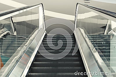 Escalator staircase view from below upwards railing Stock Photo