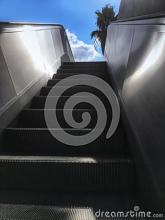 Escalator stairs leading up to sky. Concept of success Stock Photo