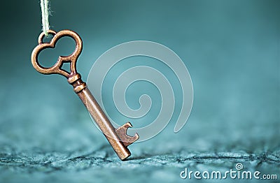 Escape room concept. Vintage key on blue background with copy space Stock Photo