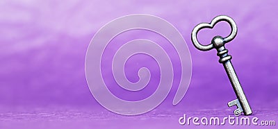 Escape room concept. Vintage key on purple background, web banner Stock Photo