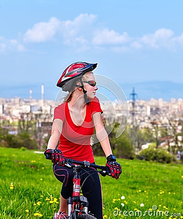 Escape urban . Bicycle girl wearing helmet rest from city urbanization. Stock Photo