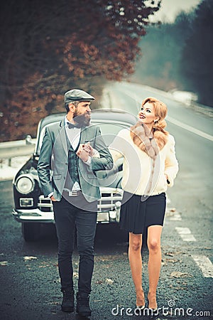 Escort of girl by security. escort concept with bearded driver and luxury girl in retro car. Stock Photo