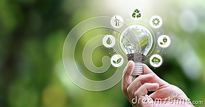 ESG Banners - Environment, Society and Governance hand holding light bulb with renewable energy icon Revolving Revenue Stock Photo