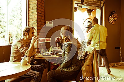 Eskisehir, Turkey - April 15, 2017: Couple sitting at a cafe table. Editorial Stock Photo