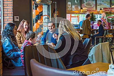 Eskisehir, Turkey - April 15, 2017: Family sitting in cafe shop Editorial Stock Photo