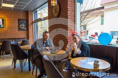 Eskisehir, Turkey - April 15, 2017: Family sitting in a cafe shop Editorial Stock Photo