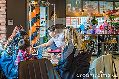 Eskisehir, Turkey - April 15, 2017: Family sitting in cafe shop Editorial Stock Photo