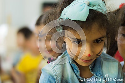 Eskisehir, Turkey - May 05, 2017: Preschool little girl wearing blue jacket enjoying being with her friends. Editorial Stock Photo