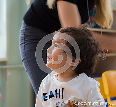 Eskisehir, Turkey - May 05, 2017: Sweet little boy with his mother behind in kindergarten classroom Editorial Stock Photo