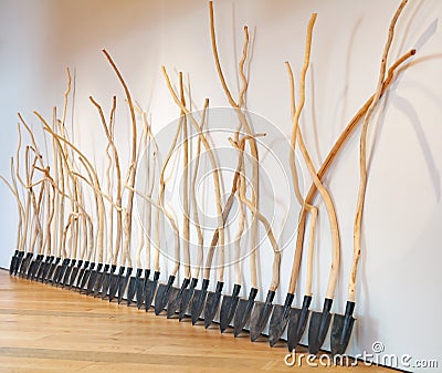 Group of shovels with handles made of curved tree branches leaning to the wall in Odunpazari Modern Museum Editorial Stock Photo
