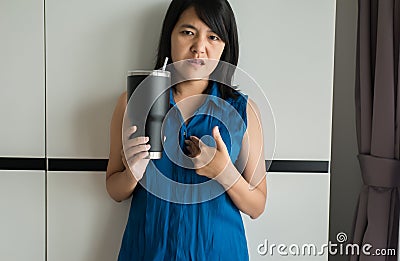 Asian woman having or symptomatic reflux acids,Gastroesophageal reflux disease Stock Photo