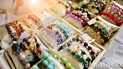 Esoteric and colorful background. Gemstone bracelets and necklaces. Healing, powerful crystal and stones energy. Stock Photo