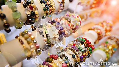 Esoteric and colorful background. Gemstone bracelets and necklaces. Healing, powerful crystal and stones energy. Stock Photo