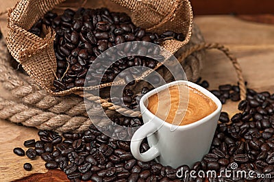 Espresso and Coffee Beans in burlap bag Stock Photo