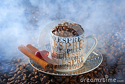 Espresso coffee cup in an environment of fried coffee grains Stock Photo