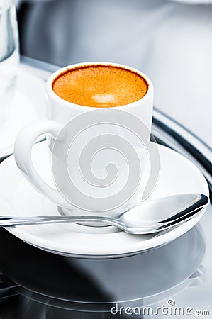 Espresso coffee full cup and saucer on bedside table closeup Stock Photo