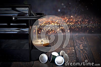 Espresso coffee maker and capsules on a wooden table Editorial Stock Photo