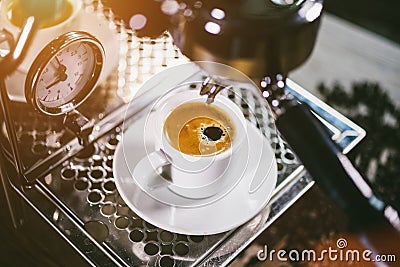 Espresso out of classic coffee machine into coffee cup Stock Photo