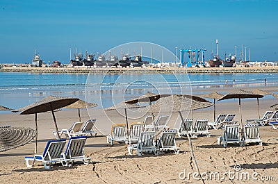 Empty umbrellas and sun loungers on the beach of Essaouira, Morocco Stock Photo