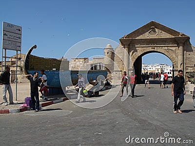 Group of people at the entrance arch of the fishing port of Essaouira, Morocco Editorial Stock Photo
