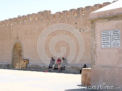 Group of people next to a wall in Essaouira, Morocco Editorial Stock Photo