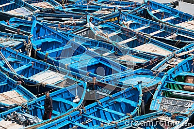 Essaouira, Morocco - March 16, 2018: A multitude of blue fishing boats typical of the city stuck together Editorial Stock Photo