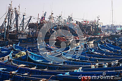 ESSAOUIRA, MOROCCO - SEPTEMBER 29. 2011: Countless blue fishing boats squeezed together in an utterly cramped harbor Editorial Stock Photo