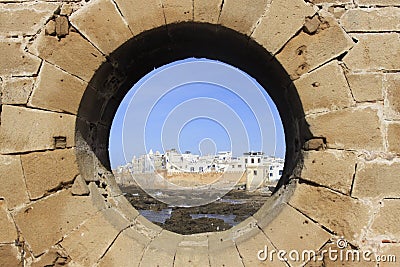 Essaouira Ramparts view through a fortress window in Morocco. Essaouira is a city in the western Moroccan region on the Stock Photo