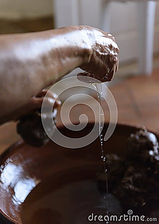 Making Argan Oil by Hand - squeezing pulp to release oil Stock Photo