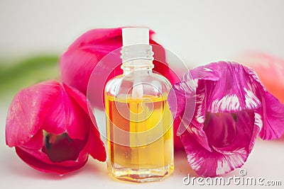 Essence of flowers on table in beautiful glass jar Stock Photo