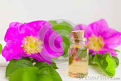 Essence of flowers on table in beautiful glass jar Stock Photo