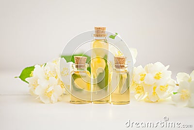 Essence of flowers on table in beautiful glass jar Stock Photo