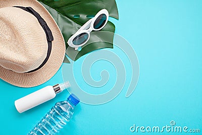 Essential accessories for summer heat: sunglasses, hat, sunscreen, bottle of water. Flat lay, top view Stock Photo