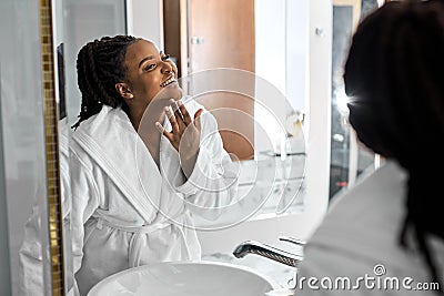 Essential Beauty.Black woman touch flawless skin, attractive african american lady enjoying result of beauty treatments Stock Photo