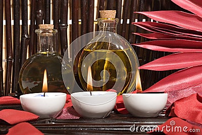 Essential body massage oils with candles Stock Photo