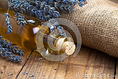 Essential oil botle and lavender flowers Stock Photo