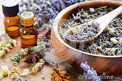 Essential oils with dried herbs Stock Photo