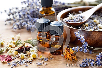 Essential oils with dried herbs Stock Photo