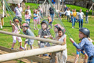 Kids practicing with the catapult in the Norman village. Reconstruction of medieval period 1050, educational centre for kids with Editorial Stock Photo