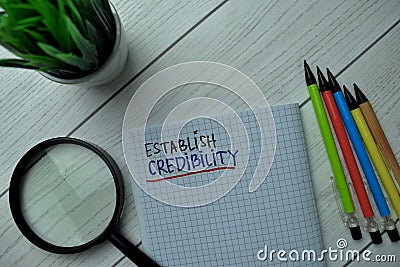 Establish Credibility write on a book isolated on office desk Stock Photo
