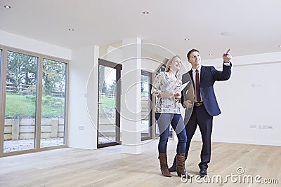 Estate Agent Showing Prospective Female Buyer Around Property Stock Photo