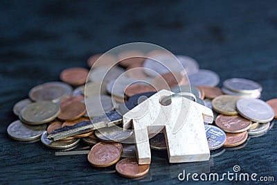 Estate concept, keychain with house symbol, The keys are placed on a black background coin. Stock Photo