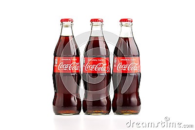 Estonia, Tallinn - 14.02.2021: Coca-Cola Classic in a glass bottle Isolated on white. three bottles of Coca-Cola Editorial Stock Photo