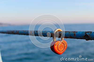 Eternal love symbol red heart. the tradition of hanging a lock on the railing. lovers locked the lock on the fence as a sign of lo Editorial Stock Photo