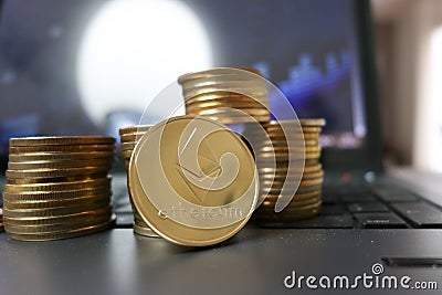 Ether coins or ethereum on graph computer background to illustrate blockchain and cyber currency ETH Editorial Stock Photo