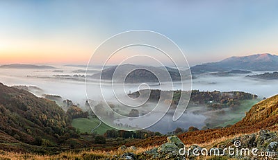 Ethereal autumn sunrise over the Langdale valley, Lake District Stock Photo