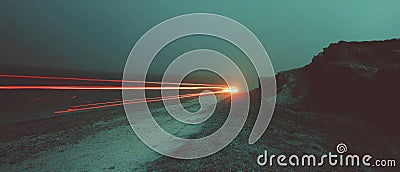 Ethereal light trails create dynamic patterns on a dark background Stock Photo
